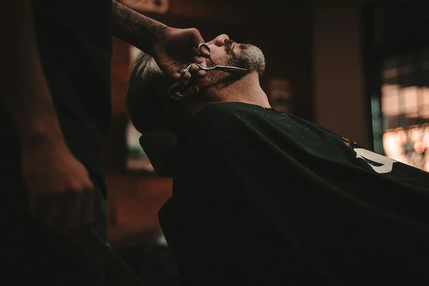 Warmly lit barbershop with classic chairs and grooming tools